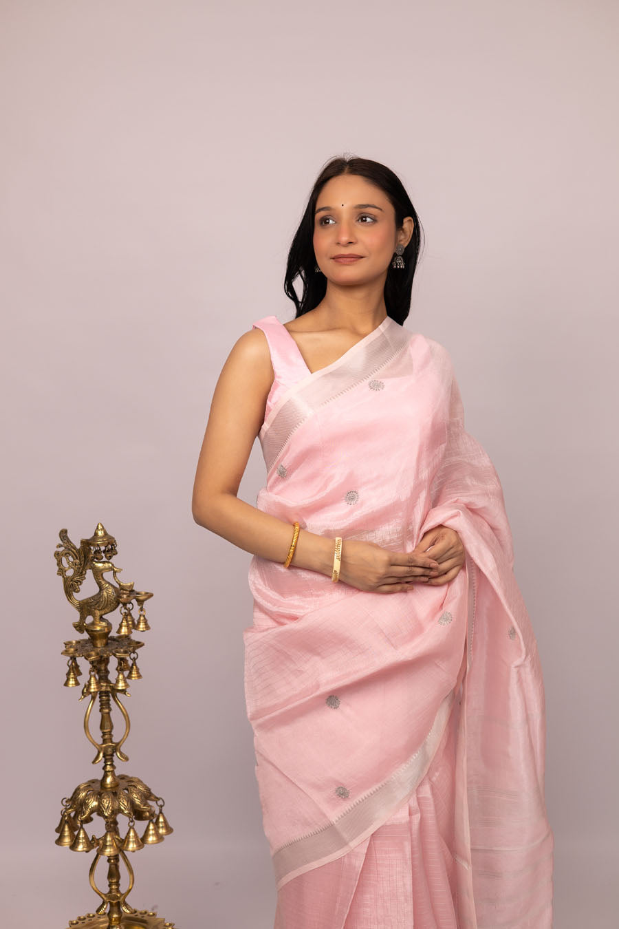 Woman wearing a light pink handembroidered chikankari sare-front view