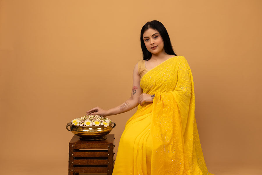 Lady celebrating Haldi ceremony in yellow hue in the comfort of summer