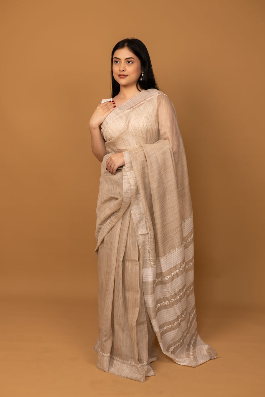 Woman wearing beige handwoven cotton saree front view with minimal stripe design