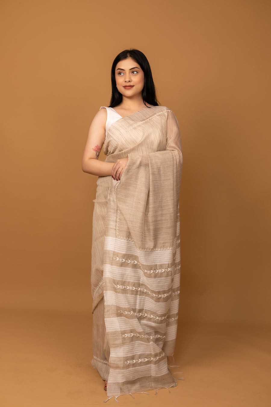 Full look of beige handwoven cotton saree with subtle textured stripes