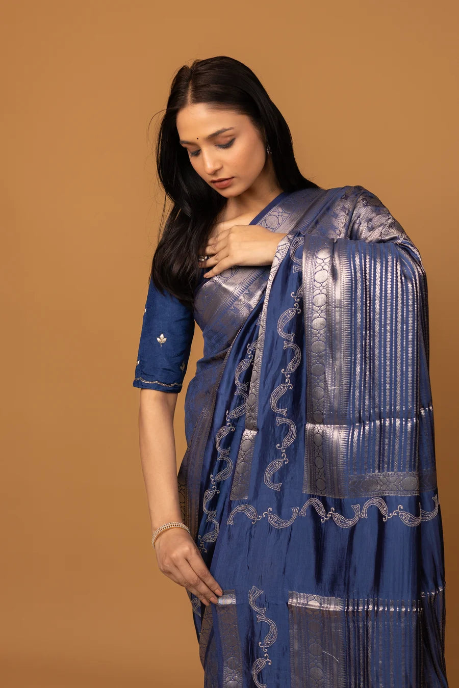 Close-up of zari weaving on navy silk saree